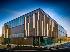 an office building with many windows and lots of parking spaces