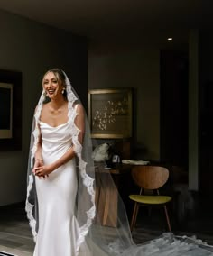 a woman in a white wedding dress and veil