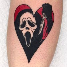 a heart shaped tattoo with a skeleton holding a knife in it's mouth and wearing a mask