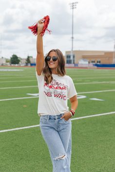 Designed for the ultimate Georgia Bulldog fan, this cream graphic tee is a must-have addition to your wardrobe. Made from 100% cotton, the short sleeve tee features a bold football helmet graphic and "The Bulldogs Rock The Who" text. With a relaxed fit and round neckline, it's the perfect option for game day or everyday wear. Simply style it with your favorite denim jeans and sneakers to complete the look. Graphic Tee For Game Day And Summer, Summer Game Day Graphic Tee, White T-shirt For Summer Fan Gear, White Soft-washed Tops For Game Day, Summer Cotton T-shirt With Team Spirit Style, Summer Cotton T-shirt With Team Spirit, Summer Game Day Cotton T-shirt, Summer Cotton T-shirt For Game Day, Spring Team Spirit Short Sleeve T-shirt