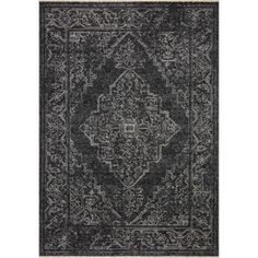 a black and white rug with an ornate design on the bottom, in front of a white background