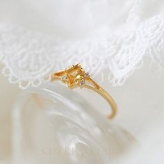 Kite Shape Citrine Dainty Gold Ring, Split Band Engagement Ring, November Birthstone Jewelry, Unique Crystal Rings, Citrine Rose Gold Ring DETAILS ♡⃛ ⃛ Main stone: Citrine Side stone: Moissanite Band width: 1.5mm Band thickness: 1.2mm OUR GEMSTONES ♡⃛ ⃛ At Kiseki Kiara, we use both precious and semi-precious stones throughout our jewelry designs, with each stone set-by-hand in our workshop. We carefully source gemstones for their quality and color ensuring you receive the best quality stones. Al Elegant Yellow Sapphire Ring For Wedding, Exquisite Diamond Ring With Gemstone Accents As Gift, Fine Jewelry Citrine Birthstone Promise Ring, Citrine Birthstone Promise Ring In Fine Jewelry, Elegant Yellow Sapphire Topaz Ring With Accent Stones, Elegant Promise Flower Ring With Birthstone, Elegant Yellow Sapphire Wedding Ring, Elegant Citrine Crystal Ring With Gemstone, Elegant Citrine Crystal Ring With Birthstone