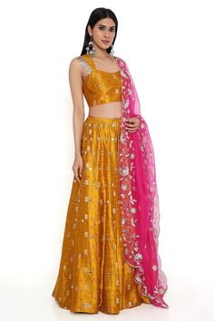 Yellow silk lehenga in bandhani pattern with mirror embroidery and attached cancan crafted in silk. Paired with an embroidered tasseled blouse and pink organza dupatta.
Components: 3
Pattern: Embroidered
Type Of Work: Mirror, Thread
Neckline: Sweetheart
Sleeve Type: Sleeveless
Fabric: Silk, Organza
Color: Yellow
Other Details: 
Lehenga length: 45 inches
Model Height: 5ft 8inches, wearing size M
Lehenga closure: Hook and Eye
Disclaimer: Since the designer is a made-to-measure brand and the dyeing Yellow Silk Lehenga, Bandhani Pattern, Yellow Mirror, Payal Singhal, Mirror Embroidery, Yellow Silk, Silk Lehenga, Organza Dupatta, Saree Dress