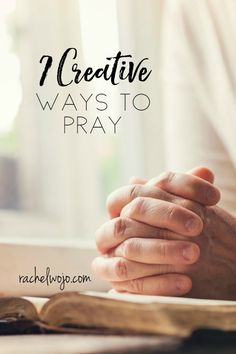 hands folded in prayer over an open book with the words 7 creative ways to pray