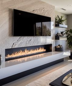 a living room with a large fireplace in the center and a tv on the wall