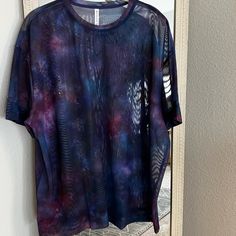 Size Medium. New With Tags! See Through With A Super Nova Galaxy Print. Could Be Great As A Swim Cover Up. Approximate Measurements (Laying Flat): Bust: 26” Length: 29” Oversized Purple Tops For Streetwear, Purple Stretch Sporty Tops, Sporty Stretch Purple Tops, Purple Workout T-shirt, Purple Athleisure Tops For Sports, Purple Relaxed Fit Sporty Tops, Purple Short Sleeve Activewear For Sports, Purple Short Sleeve Activewear For Workout, Purple Sporty Top For Summer