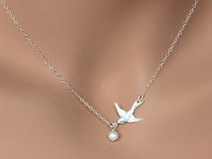 Dove Bird Necklace, Freshwater Pearl Necklace This necklace express for love and friendship All metal components onto High Quality Sterling Silver or 14k gold fill. This beautiful necklace consists of, -Sterling Silver Dove Pendent, -5mm Gem quality Freshwater Pearl and -Sterling Silver cable chain with end to end to Spring Claw. -Come up with beautiful ribbon gift box and -Care instruction pack . MORE BIRD https://www.etsy.com/shop/rainbowearring?ref=hdr_shop_menu&search_query=bird PET LOVE Adjustable Bird Design Jewelry For Gifts, Adjustable Bird Design Jewelry As Gift, Adjustable Bird Design Jewelry Gift, Elegant Bird Design Jewelry For Gift, Elegant Bird Design Jewelry Gift, White Bird-shaped Jewelry Gift, Round Necklace With Bird Design For Gift, Bird Design Necklace Gift, Elegant Bird Design Jewelry For Anniversary