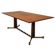 a wooden table with two metal legs and a square shaped center piece on one end