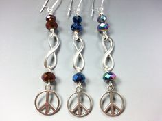 "These Pretty, Extra Sparkly Earrings are part of my \"For a More Peaceful World\" Collection. They are made from Tibetan Silver Peace Symbols and Infinity Signs with Titanium Plated Crystal Beads in your choice of 3 Colors: Dark Purple, Brilliant Blue, and Multi-Color Rainbow. They are 2-3/4 inches long ( not including the silver plated Kidney Style ear wires) and are very light weight. It's possible for me to make this same style of earrings with Other Colors of Crystal Beads. Please message m Infinity Signs, Peace Symbols, Semiprecious Stone Jewelry, Color Rainbow, Sparkly Earrings, Dark Purple, Stone Jewelry, Ear Wires, Peace Symbol