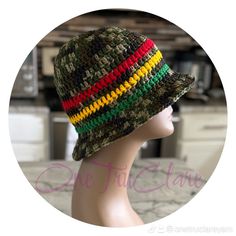 a knitted hat with multi - colored stripes on it's brim sits on a mannequin head