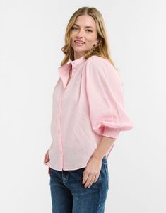 DESCRIPTION Add a touch of femininity to your wardrobe with the Clara Shirt by Italian Star in soft pink. This charming shirt features a delicate stand collar and a button-through front, exuding effortless elegance. The voluminous sleeves with gathered cuffs add a playful touch, while the relaxed fit ensures all-day comfort. Perfect for both work and casual wear, this versatile shirt will quickly become a staple in your collection. For a polished office look, pair the Clara Shirt with tailored b Pink Shirt Outfit, Embrace Femininity, Outfit Office, Soft Pink Color, Voluminous Sleeves, Office Look, Effortless Elegance, Pink Shirt, A Stand