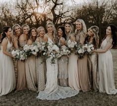 a group of women standing next to each other holding bouquets