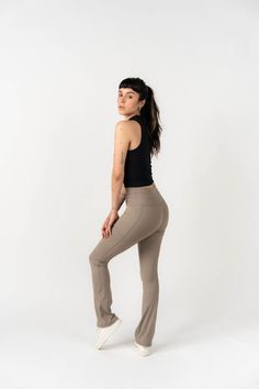 a woman is posing for the camera in her yoga pants