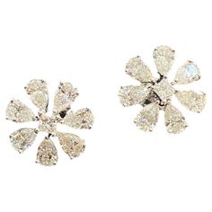 This elegant stud earrings feature a remarkable 4.50 carats of pear princess natural diamonds, set within a beautiful big flower design crafted from 14K white gold! Specifications : Diamond Weight : 4.50 Cts [4.20 Cts Pear + 0.30 Cts Princess] Diamond Shape : Pear & Princess Diamond Color Grade : F Diamond Clarity Grade : VS1 Gold Color : White Gold Gold Purity : 14K Closure : Screw Back (pierced) Style : Stud Earrings Width : 16.10 MM SKU : E-736 Our Promise : 1.) HIGH Quality Products. 2.) All our products are accomanpied with Hallmark Stamps and Certificates. 3.) We have all sizes, shapes, color, clarity GIA & IGI Ceritifed Diamonds Available. 4.) We do make Custom Designs. Please contact for Custom Designs. 5.) Customization like Ring Size, Length can be done at Free of Cost. 6.) Free Big Flower Design, Diamond Color Grade, Flower Stud Earrings, Flower Stud, Princess Diamond, Big Flowers, Flower Earrings Studs, Flower Studs, Diamond Color