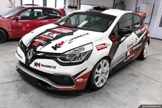 a white and red car parked in a garage