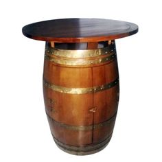 a wooden barrel table sitting on top of a white floor