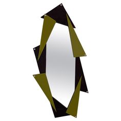 a mirror that has some black and green shapes on it