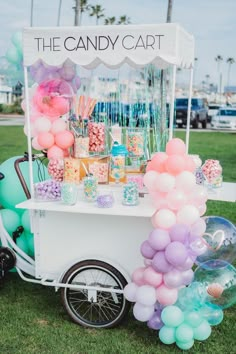 the candy cart is decorated with balloons and confetti