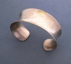 Elegant with a minimalist aesthetic, this slim line bronze cuff is a comfy easy-to-wear bracelet. Handmade in solid bronze, it's first hammered for a shimmery facet texture, molded into curvy contours, then polished to reveal the metal's lovely champagne blush tones. So versatile, wear it with your little black cocktail dress and on the weekends with your favorite pair of jeans. It goes with everything! Band width is just under 1 inch (2.4cm). Makes an ideal 8th or 19th anniversary gift as bronz Bronze Cuff Bracelet, 19th Anniversary Gifts, Bronze Anniversary Gifts, 19th Anniversary, Bronze Anniversary, Little Black Cocktail Dress, Cuff Bracelets Handmade, Anniversary Gift For Wife, Blush Tones