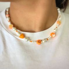 Click here for this cute and flirty choker/necklace. This adorable handmade orange necklace is everything you need to show your y2k aesthetic. This necklace includes an assortment of beads and is 16 inches in length and includes an extender to fit you perfectly.  If you think you need a little extra length, please let me know and I would be happy to make sure to give you enough length. White Beaded Y2k Style Jewelry, Handmade White Y2k Style Jewelry, Trendy Pearl Necklace With Colorful Beads, Orange Choker Necklace For Gift, Trendy Orange Festival Jewelry, Adjustable Orange Beaded Necklace With Letter Beads, Orange Necklace With Letter Beads For Gifts, Orange Beaded Choker Necklace For Festivals, Orange Beaded Choker For Festivals