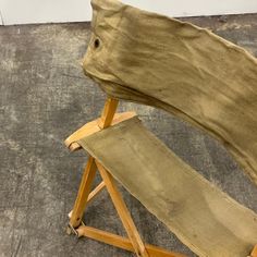 a wooden chair sitting on top of a cement floor