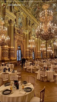 an ornately decorated ballroom with chandeliers and tables