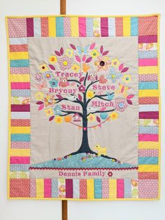 a quilt hanging on the wall with a tree