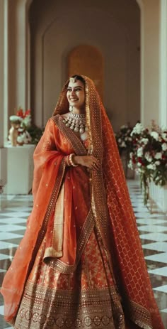 a woman in an orange and gold bridal gown