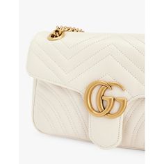 Find GUCCI Marmont Quilted Leather Shoulder Bag on Editorialist. This Gucci shoulder bag is crafted from quilted leather and features a clasp fastening, adjustable strap, front flap, brand plaque at the front, one main compartment, interior zipped pocket, and a lined interior. It measures 13cm in height, 21.5cm in width, and 6.5cm in depth. The bag can be worn on the shoulder or crossbody and comes with a dust bag. White Leather Shoulder Bag With Cc Turnlock Closure, Luxury White Shoulder Bag With Turn-lock Closure, Designer Gucci Bag In Soft Leather, Designer Gucci Soft Leather Bag, Designer White Shoulder Bag With Turn-lock Closure, Luxury Quilted Leather Flap Bag, Gucci Luxury Soft Leather Shoulder Bag, Gucci Leather Bag With Turn-lock Closure, Luxury Gucci Shoulder Bag In Soft Leather