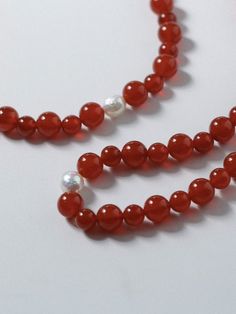 Enhance your style with our stunning Natural Red Agate Necklace and Bracelet set, symbolizing the vibrant energy of the New Year with hues of luck and prosperity. Perfect for the Lunar New Year, these unique pieces feature natural agate beads in shades ranging from translucent tomato red to rich cherry red. Pairing elegance with sophistication, this set is a must-have for the upcoming celebrations. Metal: 18K Recycled Gold Plated On Brass Gemstone: Red Agate/Freshwater Baroque Pearl Pearl/Agate Red Agate Beaded Necklaces With Round Beads, Spiritual Red Jade Jewelry, Elegant Red Carnelian Beaded Bracelets, Elegant Good Luck Bracelets With Natural Stones, Elegant Red Agate Beaded Bracelets, Elegant Red Agate Bracelets, Red 8mm Beads Jewelry For Meditation, Elegant Red Carnelian Bracelet, Elegant Red Beaded Bracelets For Meditation