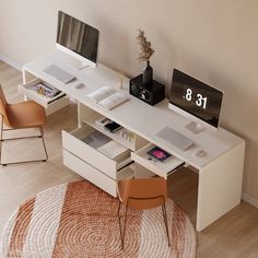 a white desk with two computers on it and a rug in front of the desk