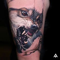 a man with a wolf tattoo on his arm