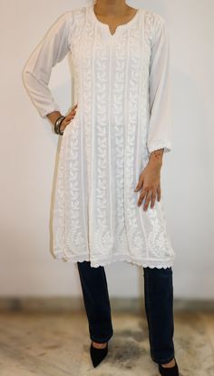 Experience the timeless elegance of our A-line 8 Kali panel tunic, a masterpiece of artisanal craftsmanship. This tunic, with its split neckline and full sleeves, exudes a blend of tradition and contemporary charm. The entire front and back are adorned with intricate chikankari hand embroidery, showcasing delicate patterns that tell a story of meticulous dedication. The hem is gracefully finished with hand-crocheted edges, adding a touch of vintage allure. With a length of 38 inches, this tunic offers both style and comfort, making it a versatile addition to your wardrobe. length - 38 inches Sizes -  S - fits bust 34 M - fits bust 36 L - fits bust 38 XL - fits bust 40 0X - fits bust 42 1X - fits bust 44 Prewashed. Preshrunk. Requires normal machine wash and line dry with light ironing for Transitional Long Sleeve Dresses With Resham Embroidery, Long Sleeve Dresses With Resham Embroidery For Transitional Season, Festive Long Sleeve Kaftan, Traditional Long Sleeve Blouse For Fall, Bohemian Long Sleeve Fitted Kurta, Spring Long Sleeve Kurta With Resham Embroidery, Bohemian Fitted Long Sleeve Kurta, Fitted Long Sleeve Bohemian Kurta, Long Sleeve Kurta With Resham Embroidery For Spring