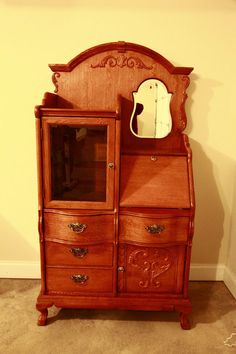 a wooden dresser with a mirror on top of it