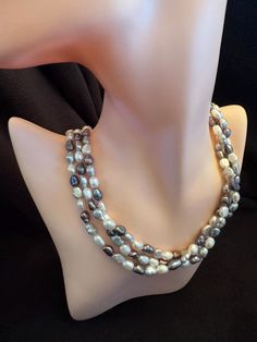 Don't miss our liquidation sale on this stunning multicolor triple strand freshwater baroque pearl necklace! Measuring 18 inches in length, this exquisite piece features 6-7mm baroque-shaped pearls in a beautiful mix of natural and tinted colors, adding a vibrant touch to any outfit. The necklace is secured with a durable silver clasp, ensuring both beauty and reliability. Perfect for elevating your everyday style or adding flair to special occasions, this necklace is a fantastic value. Details: Pearl Type: Freshwater (Baroque Shape) Pearl Size: 6-7mm Length: 18 inches Clasp: Solid 925 Silver  Style: Triple Strand Condition: New Color: Multicolor (Natural & Tinted) Liquidation Sale, Baroque Pearl Necklace, Pearls Necklace, Real Pearls, Wedding Jewellery Necklace, Pearl Types, Pearl Size, Baroque Pearls, Wedding Necklace