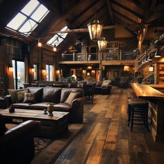 a living room filled with lots of furniture and wooden flooring next to tall windows