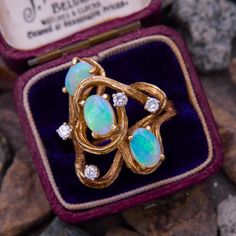 This vintage swirling ring features three oval cabochon semi-crystal Australian opals accented with gold texturing and four bright diamonds.  The ring is crafted in 14k yellow gold and is currently a size 6. Opal Rings Vintage, Vintage Opal Ring, Opal Ring Vintage, Opal Diamond Ring, Princess Ring, Swirl Ring, Opal Ring, Opal Crystal, Australian Opal