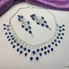 Gorgeous fine quality replica diamond and Faux Blue Sapphire  CZ stones studded necklace with a white gold rhodium plating and matching Earrings Item contains: Necklace and earrings AAA-quality cubic zirconia was used. Highest quality and craftsmanship Necklace Fitting is adjustable Earrings Closure: Pushback Necklace Closure: chain with Hook American Diamond Necklace Set, Engagement Necklace, Necklace Closure, Engagement Necklaces, American Diamond Necklaces, Zircon Necklace, Diamond Necklace Set, Studded Necklace, Set Jewelry