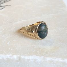 A Fine Vintage 9 carat Gold signet ring with a cabochon Bloodstone. A timeless piece that is bold and classic, a great ring for everyday wear. The detailing down the shoulders really finish it perfectly. CONDITION: Very good condition, please see photos for more detail STONE FACE: 10mm x 8mm RING SIZE: UK: I 1/2 | US: 4 1/2 RING WIDTH (SMALLEST): 2mm SETTING AND STONE HEIGHT: 5mm WEIGHT: 2.5 grams Timeless Cabochon Sapphire Ring, Classic 14k Gold Sapphire Oval Cabochon Ring, Formal Fine Jewelry Signet Ring With Cabochon, Formal Cabochon Signet Ring, Classic Cabochon Sapphire Ring For Formal Occasions, Classic Formal Cabochon Sapphire Ring, Classic Formal Sapphire Cabochon Ring, Classic Cabochon Opal Ring For Formal Occasions, Oval Cabochon Signet Ring With Polished Finish