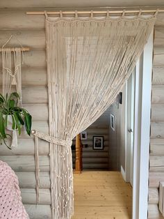 a bedroom with wooden floors and walls has a white bed cover on the top floor