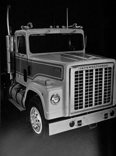 a black and white photo of a large truck