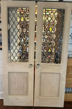 two white doors with stained glass on them