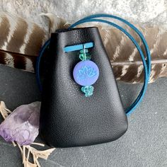 "Lotus Flowers adorn a Czech Glass Bead accented with Healing Gemstone Beads. Vegan Eco Leather Medicine Bag, Shaman Bag or Amulet Pouch to wear around your neck-or hang in your Car! Perfect for Ceremony, or to keep on your Altar. Unique and Beautiful Gift . A place for things that have Spiritual Meaning for you-like that pretty rock your 3 year old gave you.... ....And it happens to fit EarPods too....or better yet,your Prayer Beads! 3 3/4\"deep 2 3/4\"wide strap is cut out about 38\" Choice of Beaded Pouch Shoulder Bag For Gift, Beaded Pouch Shoulder Bag As Gift, Handmade Bags For Daily Use, Beaded Pouch Coin Purse, Beaded Everyday Bag, Leather Medicine Pouch, Lotus Meditation, Necklace Pouch, Crystal Pouch