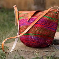 a multicolored bag sitting on top of a rock