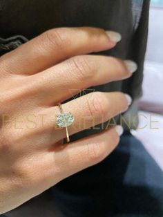 a woman's hand with a diamond ring on it