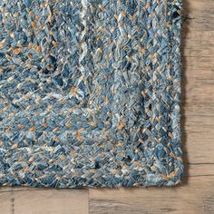 a blue rug on top of a wooden floor