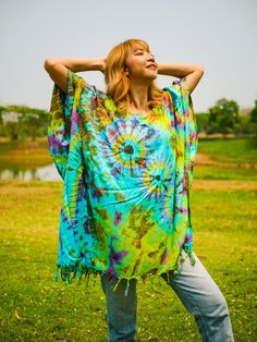 "Indulge in the unique charm of our hand-dyed tunic top, meticulously crafted for those who appreciate exceptional fashion. Made from 100% breathable and comfy rayon, this stunning piece is designed to elevate your style while ensuring absolute comfort. Our tunic top stands out with its one-of-a-kind hand-dyed method, guaranteeing that no two pieces are exactly alike. Embracing a loose silhouette, it offers a versatile fit that flatters a wide range of sizes, from S to 2XL. With its side-stitched closure and convenient armholes, this slipover style tunic top is incredibly easy to wear. A delightful feature of this blouse is the fringes decoration adorning the bottom, adding a touch of bohemian elegance to your ensemble. The tunic top measures up to 60\" in the bust and hip, providing ample Oversized Green Bohemian Tunic, Summer Beach Poncho In Green, Green Bohemian Tunic In Free Size, Free Size Green Bohemian Tunic, Green Free Size Bohemian Tunic, Casual Festival Kaftan With Natural Dye, Green Bohemian Poncho For Festivals, Casual Kaftan With Natural Dye For Festivals, Bohemian Green Free Size Tunic