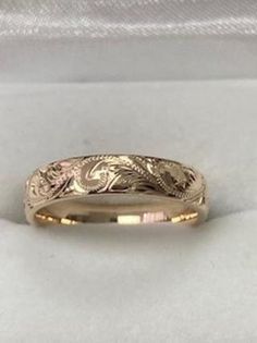 a wedding band with an intricate design on it