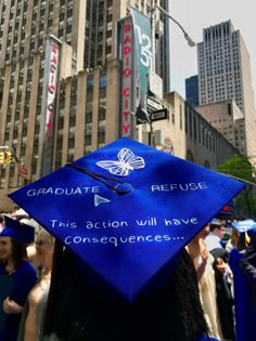 a blue graduation cap that reads graduate refuse this action will have consequentness