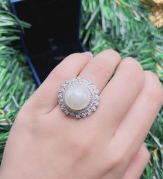 White Sea Pearl Halo Elegant Vintage Ring Pearl jewelry Stylish Ring Gift jewelry Imitation Pearl Ring jewelry Adjustable size 6-8 Exaggerated jewelry Special and unique jewelry ♥ Ready to ship ♥ The main stone is the Finest Imitation Pearl. ♥ Absolutely gorgeous and beautifully handcrafted Finest Imitation Pearl in an exquisite setting. ♥ This classic yet trendy Jewelry makes the perfect Christmas/Anniversary/Valentine's/Birthday gift for her that will be treasured forever. We have confidence t Luxury Elegant Pearl Ring With Halo Design, Luxury White Pearl Ring With Halo, Luxury Halo Pearl Ring For Anniversary, Luxury Pearl Ring With Halo Design, Diamond White Pearl Promise Ring, Diamond White Round Pearl Promise Ring, Exquisite Round Halo Ring Gift, Fine Jewelry Pearl Ring In Diamond White As Gift, Exquisite Halo Ring With Round Shape For Gift